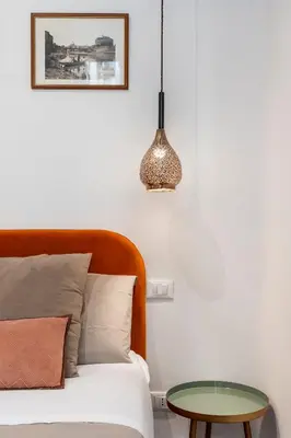 a bedroom with a bed and a table at Gracchi boutique rooms in Rome