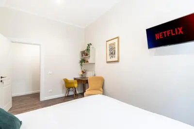 a room with a bed and a table and chairs at Gracchi boutique rooms in Rome
