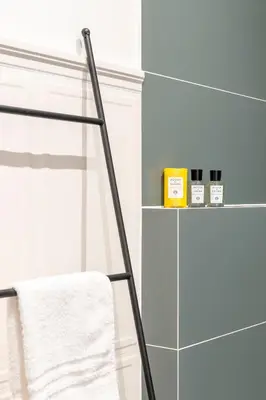 a towel rack in a bathroom with a towel at Gracchi boutique rooms in Rome