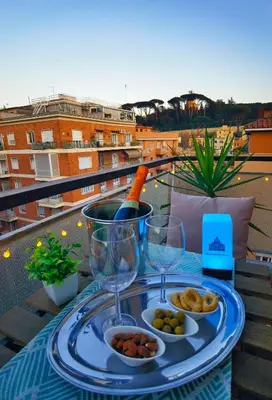 a table with a plate of food and a bottle of wine at Millelire Vatican Terrace in Rome