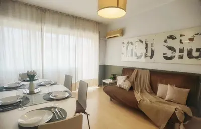 a living room with a table and a couch at Millelire Vatican Terrace in Rome