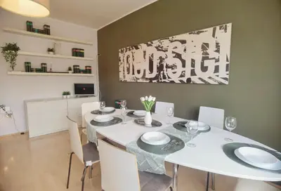 a dining room with a white table and chairs at Millelire Vatican Terrace in Rome