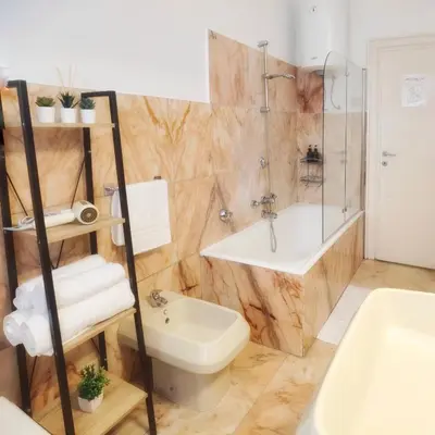 a bathroom with a toilet and a tub and a sink at Millelire Vatican Terrace in Rome