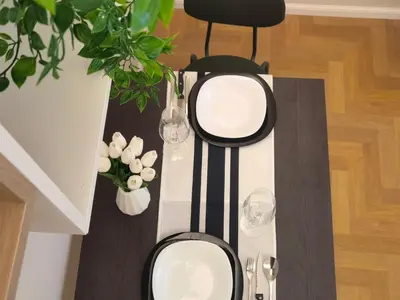 a table with plates and wine glasses on it at Metro Lodi Apartment in Rome