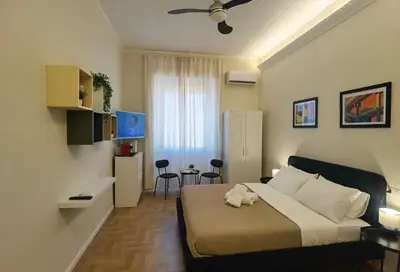 a bedroom with a bed with a stuffed animal on it at Metro Lodi Apartment in Rome