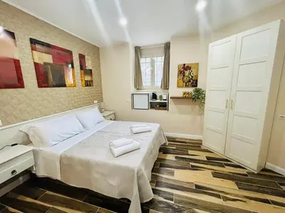 a bedroom with a bed with two towels on it at SD Vatican Rooms in Rome
