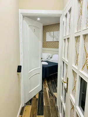 a door leading to a bedroom with a bed at SD Vatican Rooms in Rome