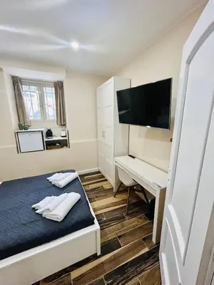 a bedroom with a bed and a desk and a television at SD Vatican Rooms in Rome