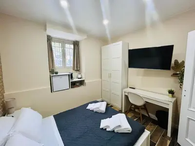 a bedroom with a desk and a bed and a desk at SD Vatican Rooms in Rome