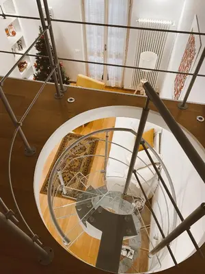 a spiral staircase with a round wooden floor at Vittoria's home in Rome