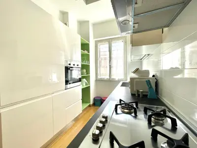 a kitchen with white cabinets and a counter top at Vittoria's home in Rome