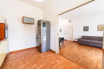 a living room with a refrigerator and a couch at Re di Roma Lodge in Rome