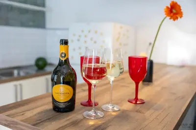 a bottle of wine and two glasses on a table at Green Hill Rome Suite Home in Rome