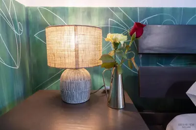 a lamp and a vase of flowers on a table at Green Hill Rome Suite Home in Rome