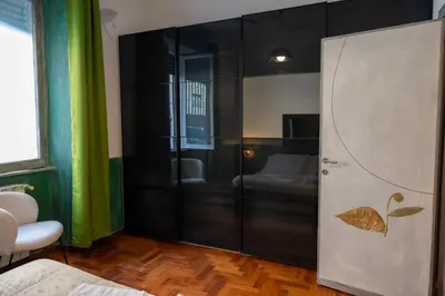 a room with a bedroom with a bed and a door at Green Hill Rome Suite Home in Rome
