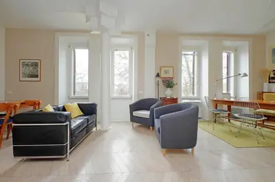 a living room with a couch and chairs and a table at YCH-Casa sul porto antico in Rome