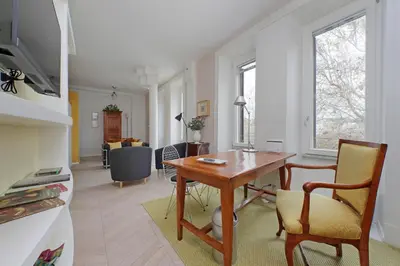 a kitchen and living room with a table and chairs at YCH-Casa sul porto antico in Rome
