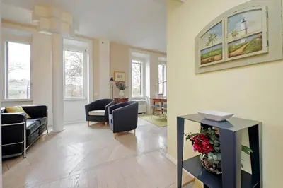 a living room with a couch and a table with flowers at YCH-Casa sul porto antico in Rome