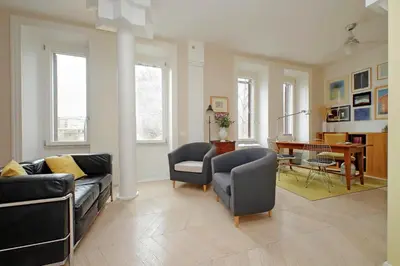 a living room with a couch and chairs and a table at YCH-Casa sul porto antico in Rome