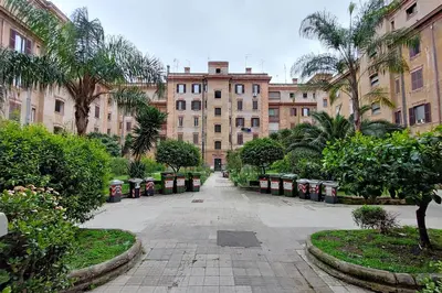 an empty street in a city with tall buildings at YCH-Casa sul porto antico in Rome