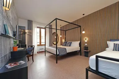 a hotel room with a bed and a mirror at Habito Suites in Rome