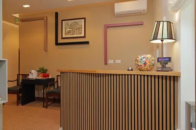 a hotel lobby with a reception desk and a lamp at Habito Suites in Rome