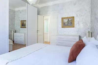 a white bedroom with a large white bed in a room at Casa Lodi Roma by Hili in Rome