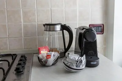 a kitchen counter top with a coffee maker and some dishes at Casa Lodi Roma by Hili in Rome