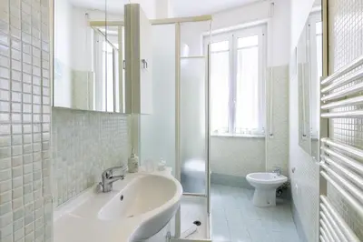 a white bathroom with a sink and a toilet at Casa Lodi Roma by Hili in Rome