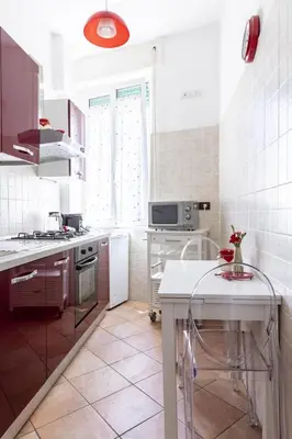 a kitchen with white appliances and a white counter top at Casa Lodi Roma by Hili in Rome