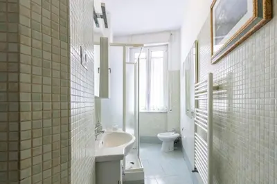 a white bathroom with a sink and a toilet at Casa Lodi Roma by Hili in Rome