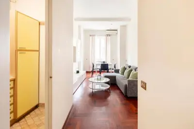 a living room with a couch and a table at Villa Borghese cozy apt in Rome