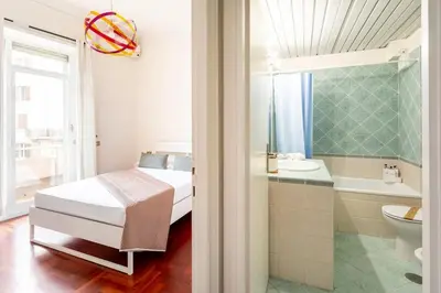 a bedroom with a bed and a tub and a sink at Villa Borghese cozy apt in Rome