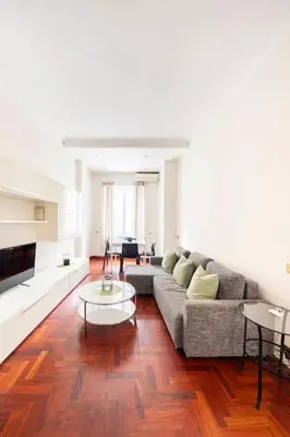 a living room with a couch and a table at Villa Borghese cozy apt in Rome