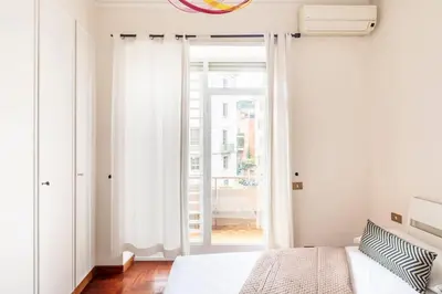 a bedroom with a bed and a window at Villa Borghese cozy apt in Rome