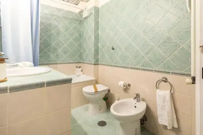 a bathroom with a toilet and a sink at Villa Borghese cozy apt in Rome