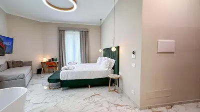 a bedroom with a bed and a couch at Vespucci Palace Roma in Rome