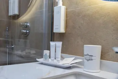 a bathroom with a sink with two cups on a counter at Vespucci Palace Roma in Rome