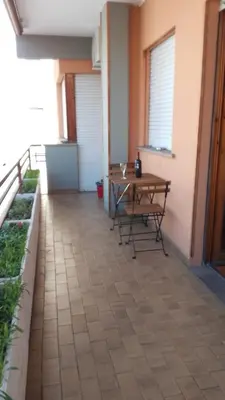 a patio with a table and chairs on a balcony at Saluzzo Apartment in Rome