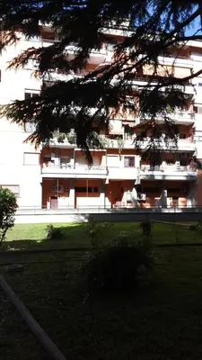 a large building with chairs in front of it at Saluzzo Apartment in Rome