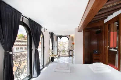 a room with a bed and a large window at Alessio Luxury House Roma Pantheon-Piazza Navona in Rome
