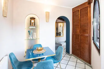 a dining room with blue chairs and a table at Alessio Luxury House Roma Pantheon-Piazza Navona in Rome