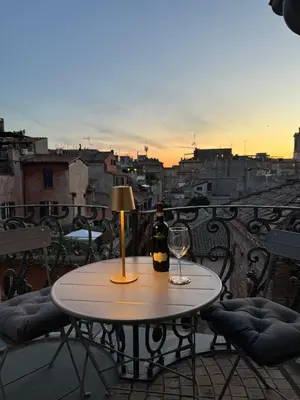 a table with a bottle of wine and a glass at Alessio Luxury House Roma Pantheon-Piazza Navona in Rome