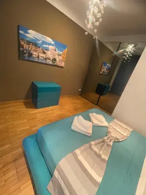 a bedroom with a blue bed and a painting on the wall at Carpegna Vatican House in Rome