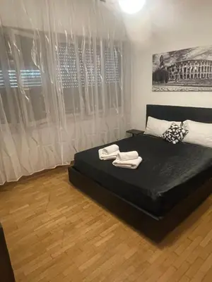 a bedroom with a bed with two towels on it at Carpegna Vatican House in Rome