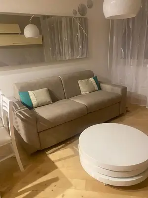 a living room with a couch and a stool at Carpegna Vatican House in Rome