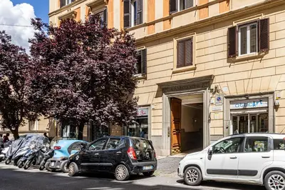 a row of cars parked in front of a building at St Peter Family Stay in Rome