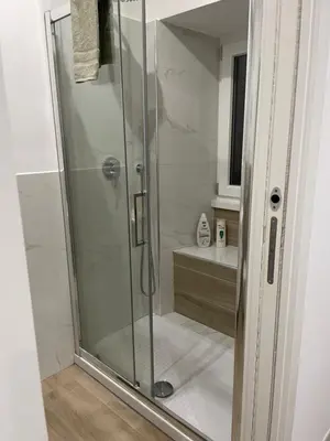 a shower with a glass door in a bathroom at St Peter Family Stay in Rome
