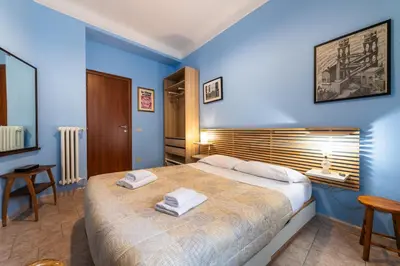 a bedroom with blue walls and a bed with towels on it at Cipro Tiny House in Rome