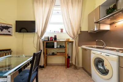 a laundry room with a washing machine and a window at Cipro Tiny House in Rome